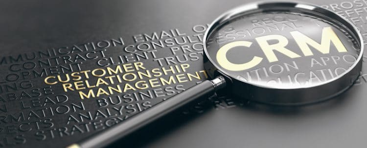 CRM Lettering in gold with magnifying glass