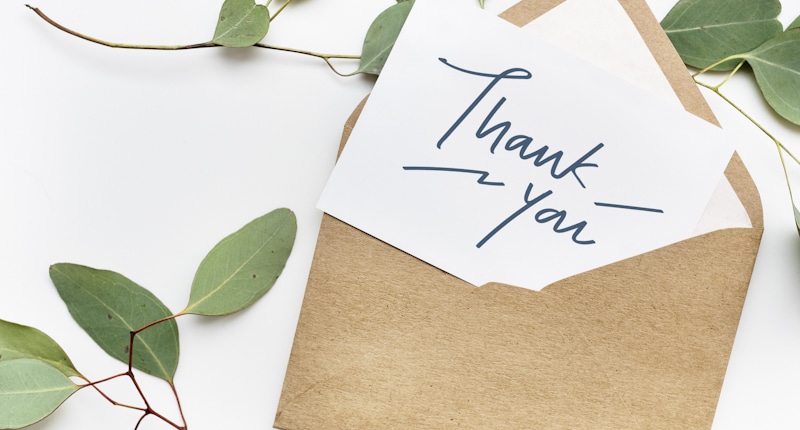 thank you note on envelope with leaves around