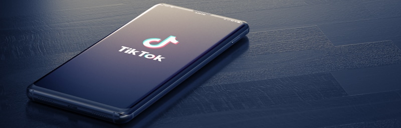 tiktok app opening on phone in dark blue table