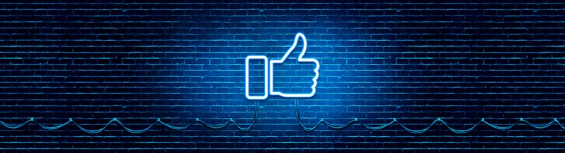 facebook like lighted neon on brick wall