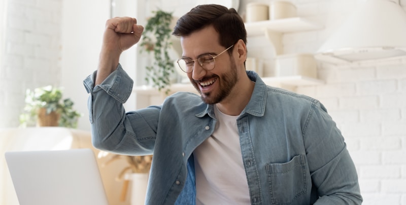 guy smiles and raises fist as he wins